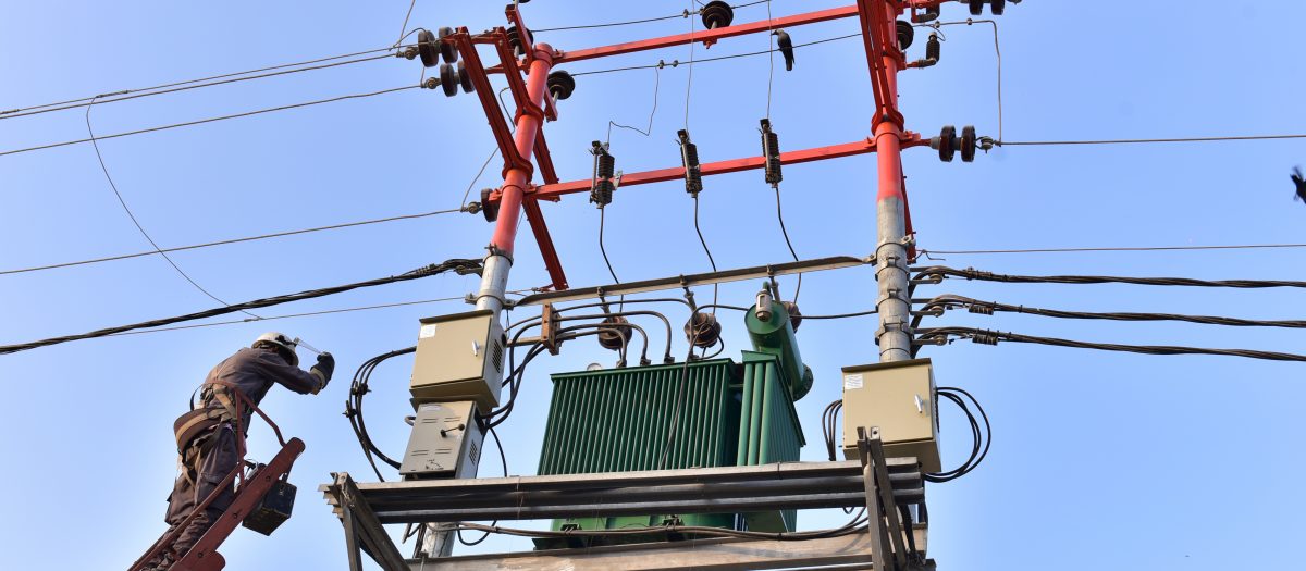 Person working on electricity tower